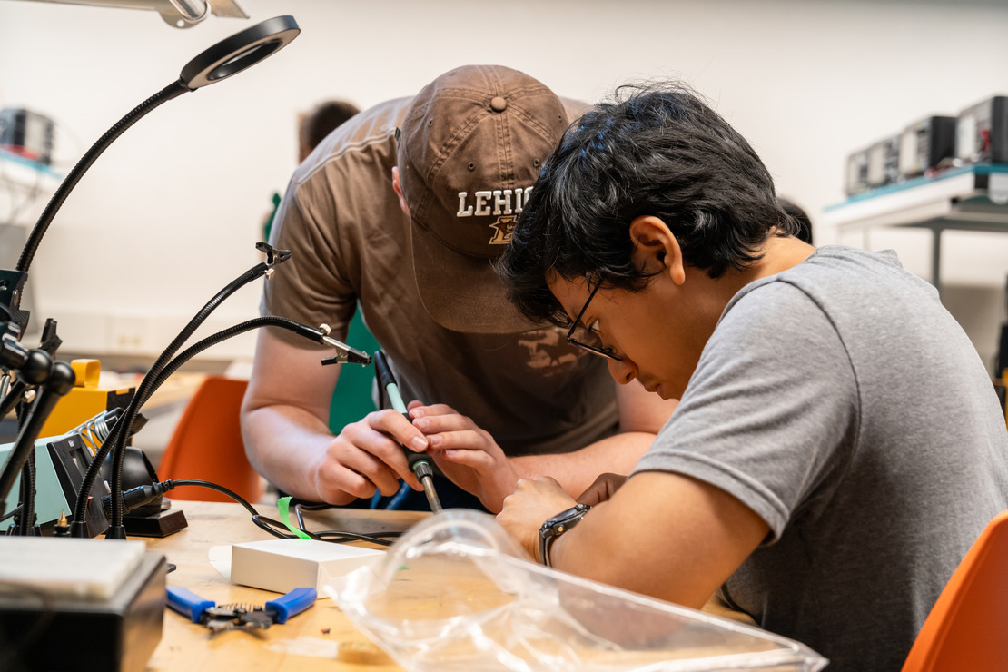 two entrepreneurship students working on a prototype
