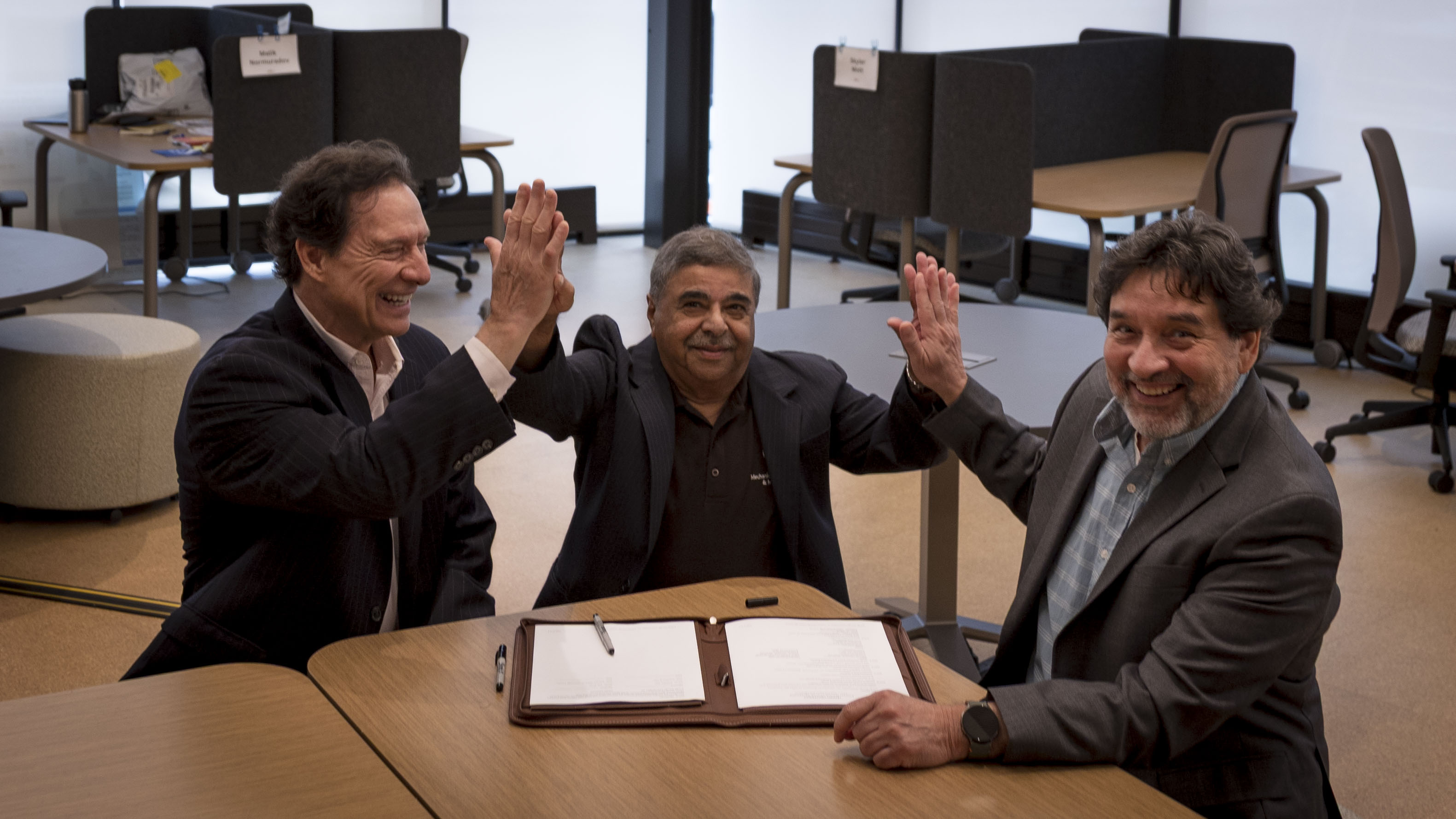 Rick Smith, Dr. Sudhakar Neti & Dr. Carlos Romero celebrate EST's express license