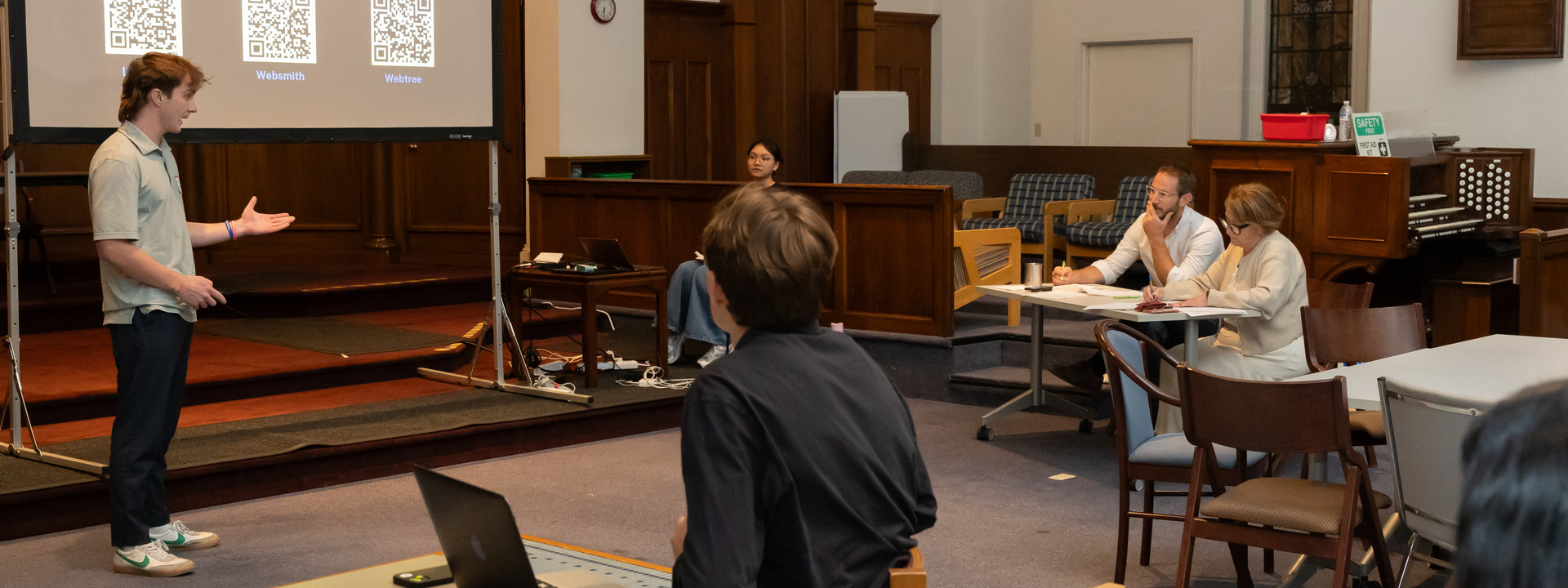 a student pitches a venture project to guest judges