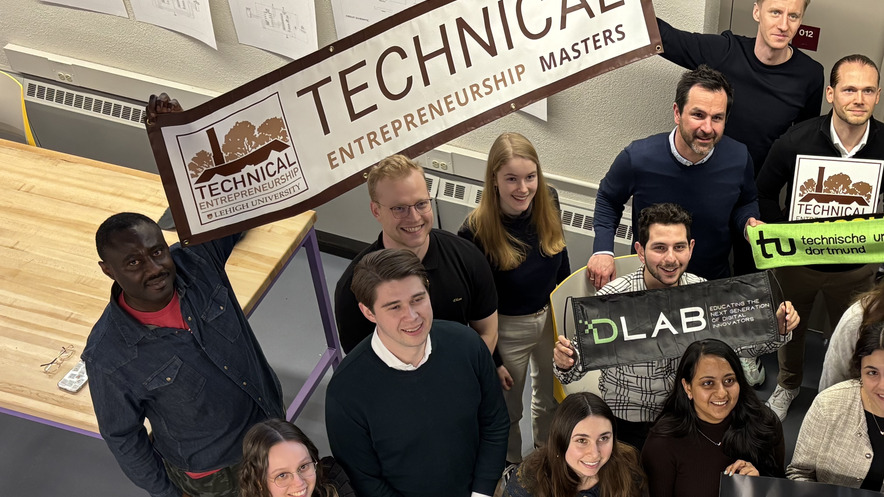 a group of TE students holding a banner