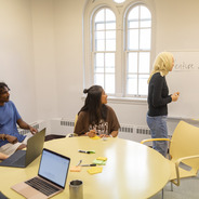 a group of students and alumni work at the Venture Studio
