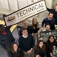a group of TE students holding a banner